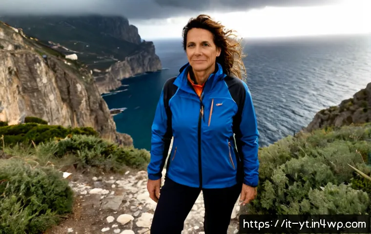 Home 17 역경을 통한 자아 인식 높이기 - Photorealistic Italian woman in her late 40s standing on a rocky coastal path above the Mediterranea...